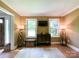 Bright living room with dual windows, hardwood floors, and a decorative area rug at 4823 Antioch Church Rd, Weddington, NC 28104
