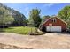 Brick home features a two-car garage and basketball hoop in front of a lush green lawn at 4823 Antioch Church Rd, Weddington, NC 28104