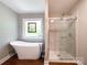 Luxurious main bathroom featuring a freestanding tub, glass shower, and modern finishes at 4823 Antioch Church Rd, Weddington, NC 28104