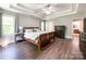 Spacious main bedroom with a tray ceiling, wood floors, and a large window at 4823 Antioch Church Rd, Weddington, NC 28104
