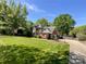 Beautiful two-story brick home with a manicured lawn, landscaping and mature trees at 4823 Antioch Church Rd, Weddington, NC 28104