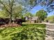 Beautifully landscaped front yard featuring lush greenery, mature trees, and a charming brick home at 4823 Antioch Church Rd, Weddington, NC 28104