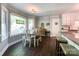 Bright dining area with a large window, a table, and dark hardwood floors at 4823 Antioch Church Rd, Weddington, NC 28104