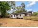 Home's backyard featuring new wood fence, manicured lawn, and covered back porch at 507 E Green St, Monroe, NC 28112