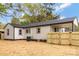 The backyard has a new wooden fence, with an air conditioner unit installed at 507 E Green St, Monroe, NC 28112