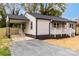 A charming home featuring a covered carport and a cozy front porch at 507 E Green St, Monroe, NC 28112