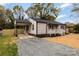 Home with covered carport, white trim, and a gravel driveway at 507 E Green St, Monroe, NC 28112