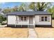 Charming single-story home with a welcoming front porch and a neatly landscaped yard at 507 E Green St, Monroe, NC 28112