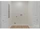 Bright laundry room featuring modern hookups, flooring, and neutral walls at 507 E Green St, Monroe, NC 28112