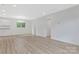 Open-concept living space with wood-look floors, fresh paint, and modern recessed lighting at 507 E Green St, Monroe, NC 28112