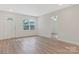 Spacious living room with modern finishes, including wood-look floors and fresh white paint at 507 E Green St, Monroe, NC 28112
