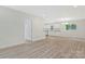 Open-concept living space with wood-look floors leading into a bright, modern kitchen at 507 E Green St, Monroe, NC 28112