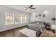 Comfortable bedroom featuring neutral tones, ceiling fan, hardwood floors, and natural light at 5119 Moselle Ave, Fort Mill, SC 29707