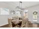 Bright dining room features a wooden table with seating for six, modern light fixture, and natural light at 5119 Moselle Ave, Fort Mill, SC 29707