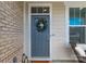 Close-up of a stylish blue front door adorned with a wreath, enhancing curb appeal at 5119 Moselle Ave, Fort Mill, SC 29707
