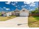 Charming single-Gathering home featuring a manicured lawn, and a large drive leading to a 2-car garage at 5119 Moselle Ave, Fort Mill, SC 29707