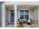 Inviting front porch featuring two wicker chairs with white cushions, perfect for relaxing and enjoying the outdoors at 5119 Moselle Ave, Fort Mill, SC 29707