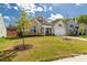 Charming single-Gathering home featuring a manicured lawn, complemented by blue sky and puffy white clouds at 5119 Moselle Ave, Fort Mill, SC 29707