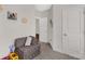 Neutral-toned hallway featuring a small sofa and carpet flooring at 5119 Moselle Ave, Fort Mill, SC 29707