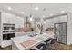 Bright kitchen with white cabinets, stainless steel appliances, a large island, and sleek pendant lighting at 5119 Moselle Ave, Fort Mill, SC 29707