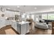 Open-concept living space with modern kitchen island, dining area, and cozy Gathering room; great for entertaining at 5119 Moselle Ave, Fort Mill, SC 29707