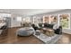 Spacious open-concept living area featuring a large sectional sofa, dining table, and a stylish area rug at 5119 Moselle Ave, Fort Mill, SC 29707
