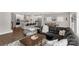 Open concept space featuring modern kitchen, dining area, and cozy Gathering room with a large sectional sofa at 5119 Moselle Ave, Fort Mill, SC 29707