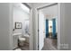 Hallway view into bathroom and bedroom with neutral paint, trim and carpet at 530 Kiser Ln, Locust, NC 28097