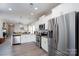 Bright kitchen features stainless steel appliances, white cabinetry, and granite countertops at 530 Kiser Ln, Locust, NC 28097