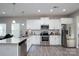 Modern kitchen featuring stainless steel appliances, granite countertops, and ample cabinet space at 530 Kiser Ln, Locust, NC 28097