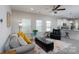 Bright living room featuring a comfortable sofa and a black leather recliner at 530 Kiser Ln, Locust, NC 28097