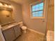 The bathroom features a single sink vanity and natural light at 5319 Springdale Ave, Mint Hill, NC 28227