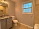 Bathroom features granite vanity, updated tile backsplash, tile flooring, and natural light at 5319 Springdale Ave, Mint Hill, NC 28227