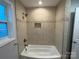 Bathroom features updated tile shower, tiled walls and floors, and natural light at 5319 Springdale Ave, Mint Hill, NC 28227