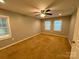 Neutral bedroom features carpet flooring, ceiling fan, and multiple windows for natural light at 5319 Springdale Ave, Mint Hill, NC 28227