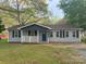 Charming single-story home featuring a welcoming front porch and a blue front door with dark shutters at 5319 Springdale Ave, Mint Hill, NC 28227