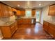 Renovated kitchen features wooden cabinets, stainless steel appliances, granite countertops, and hardwood flooring at 5319 Springdale Ave, Mint Hill, NC 28227