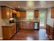 Well-lit kitchen features wooden cabinets, granite countertops, stainless steel appliances, and hardwood flooring at 5319 Springdale Ave, Mint Hill, NC 28227
