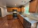 Updated kitchen features granite countertops, stainless steel appliances, wooden cabinets, and hardwood flooring at 5319 Springdale Ave, Mint Hill, NC 28227