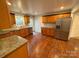 Updated kitchen features granite countertops, stainless steel appliances, and hardwood flooring at 5319 Springdale Ave, Mint Hill, NC 28227