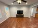 Inviting living room with a ceiling fan, hardwood floors, and a view to the front door and entry way at 5319 Springdale Ave, Mint Hill, NC 28227