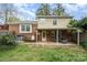 Expansive backyard featuring a patio, lush greenery, and a two-story home at 5329 Glenbrier Dr, Charlotte, NC 28212