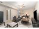 Spacious basement with cozy seating, a ceiling fan, and ample lighting, perfect for entertaining at 5329 Glenbrier Dr, Charlotte, NC 28212