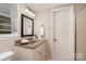 Well-lit bathroom with granite vanity, decorative mirror, and a shower stall, offering a clean and functional space at 5329 Glenbrier Dr, Charlotte, NC 28212