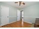 Bright bedroom with light-colored walls, hardwood flooring, and a ceiling fan fixture at 5329 Glenbrier Dr, Charlotte, NC 28212