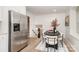 Dining area featuring a modern table, stylish chairs, adjacent refrigerator, and access to the staircase and kitchen at 5329 Glenbrier Dr, Charlotte, NC 28212