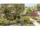 Charming home surrounded by lush landscaping, mature trees, and garden features at 5329 Glenbrier Dr, Charlotte, NC 28212