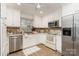 Efficient kitchen with white cabinets, stainless steel appliances, and plenty of counter space, ideal for home cooking at 5329 Glenbrier Dr, Charlotte, NC 28212