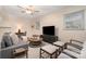 Cozy living room with modern furniture, neutral tones, and a ceiling fan providing a relaxing atmosphere at 5329 Glenbrier Dr, Charlotte, NC 28212