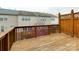 Relaxing wooden back deck with a privacy fence and views of the landscaped backyard at 5430 Dockery Dr, Charlotte, NC 28209